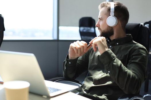 Young modern business man sitting in the office