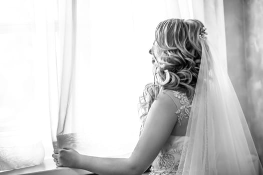 close up. happy young woman bride looking through the window. holidays and events