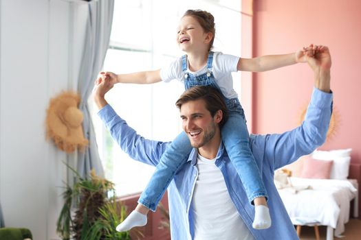 Father and his daughter child girl playing together. Father's day concept.