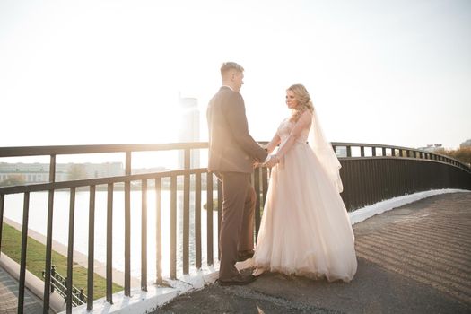 happy couple newlyweds standing on the bridge. photo with copy space