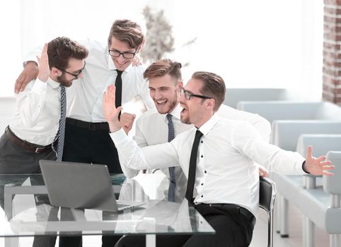 happy business team looking at the laptop screen.start-up