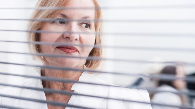 close up. Executive business woman standing near office window. business people