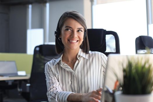 Female customer support operator with headset and smiling