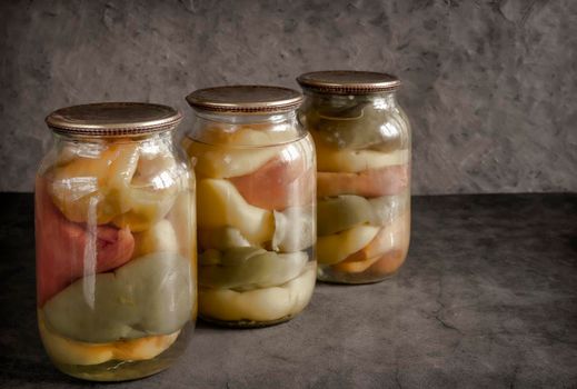 Canned bell peppers in glass jars, intended for further stuffing. Home canning. Front view, copy space