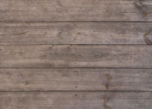 Close up background texture of vintage weathered brown wooden surface with knots and stains