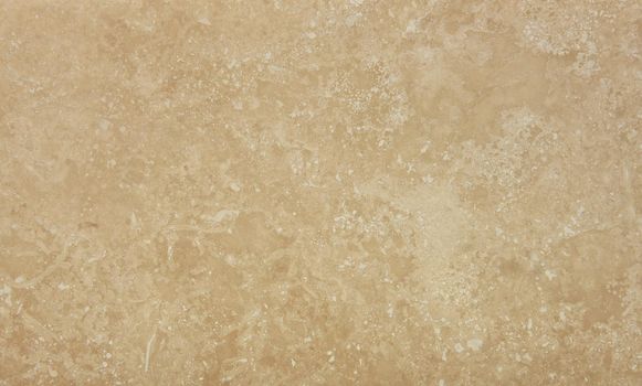 Grunge uneven brown beige marble stone texture background with cracks and stains