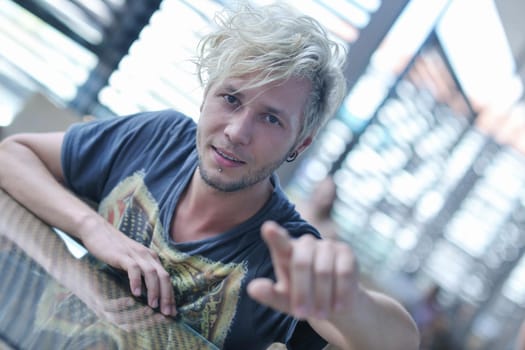 Portrait of an handsome young  man  with urban background and fashion clothes style