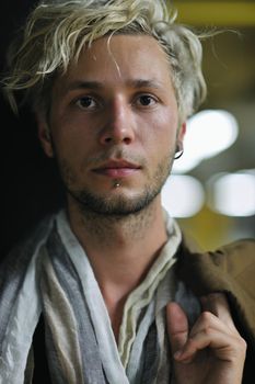 Portrait of an handsome young  man  with urban background and fashion clothes style