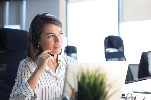 Female customer support operator with headset and smiling