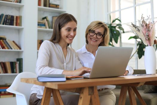 Beautiful businesswoman work together sitting on the table in office