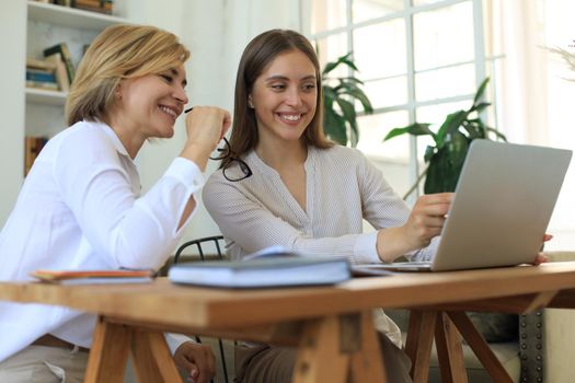 Beautiful businesswoman work together sitting on the table in office