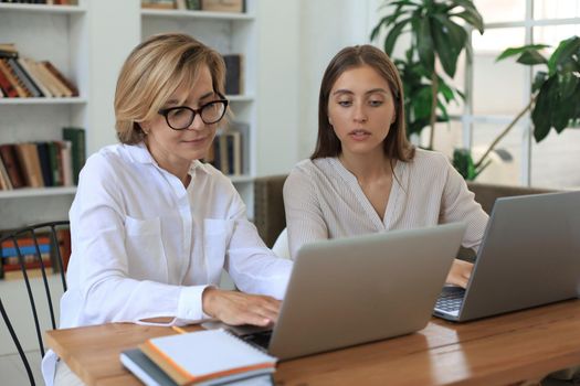 Beautiful businesswoman work together sitting on the table in office