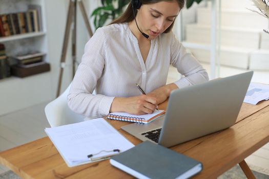 Young businesswoman works from home at the laptop during self-isolation and quarantine
