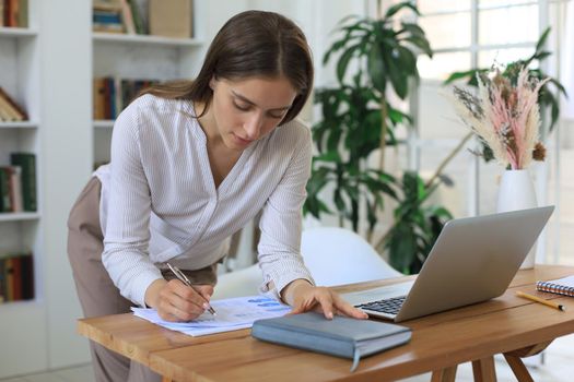 Attractive cheerful business woman working in office