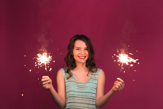 Young woman having fun with a sparkler