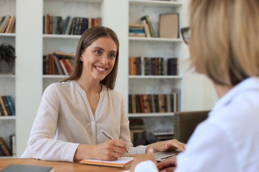 Professional middle aged female psychologist conducting a consultation