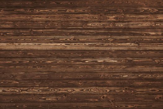 Close up background texture of vintage weathered brown wooden planks with knots and stains