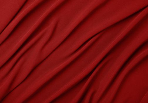 Close up abstract textile background of red folded pleats of fabric, elevated top view, directly above