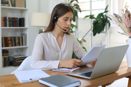 Female customer support operator with headset and smiling