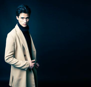 handsome asian fashion looking man posing in studio on black background, lifestyle modern people concept close up