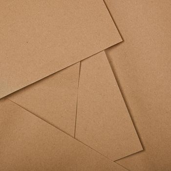 Close up abstract background of several natural brown paper sheets for design craft