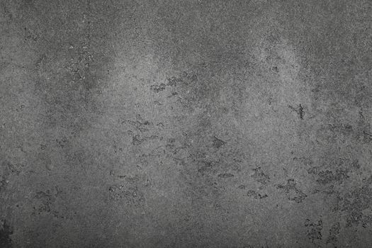 Dark gray grunge uneven concrete surface background texture