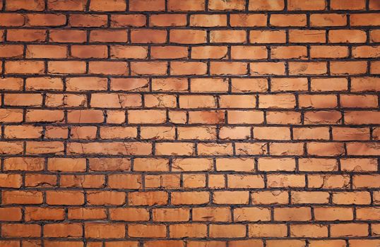 Rough brown and orange brick wall background texture close up, side view