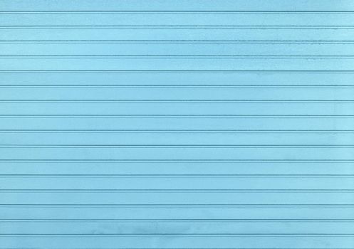 Background of pastel blue painted horizontal metal window roller shutter blinds, wood textured