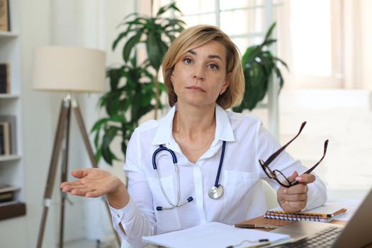 Middle aged female doctor therapist on consultation