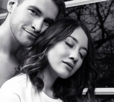young pretty couple together in bed sleeping chill, lifestyle people concept, black and white close up