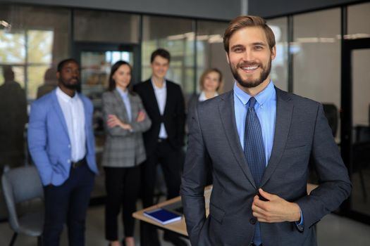 Businessman with colleagues in the background in office