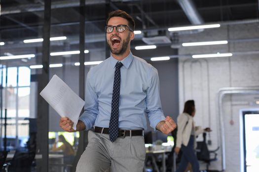 Excited business man celebrating success in the office