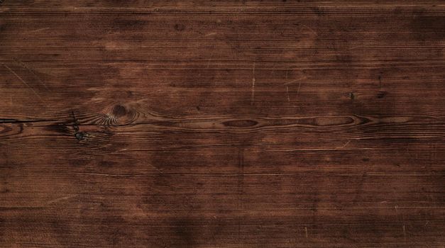Close up background texture of vintage weathered dark brown wooden surface with knots and stains