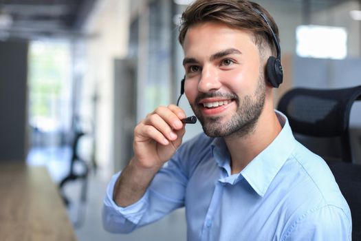 Smiling friendly handsome young male call centre operator