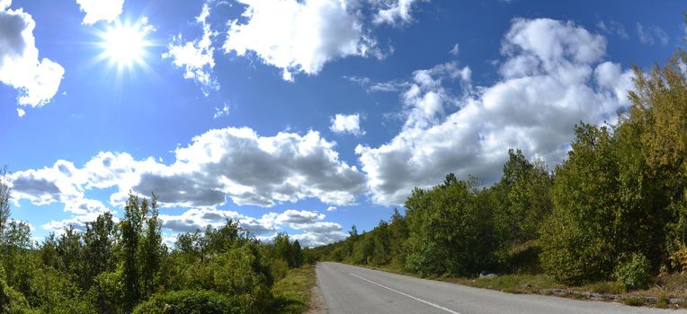 country road asphalt lines with beautiful nature and sunny summer day with blue sky