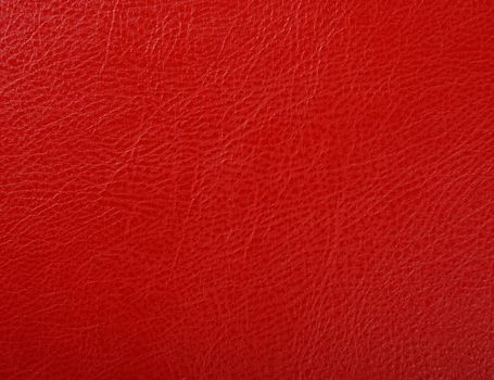 Close up background texture pattern of scarlet red natural leather grain, directly above