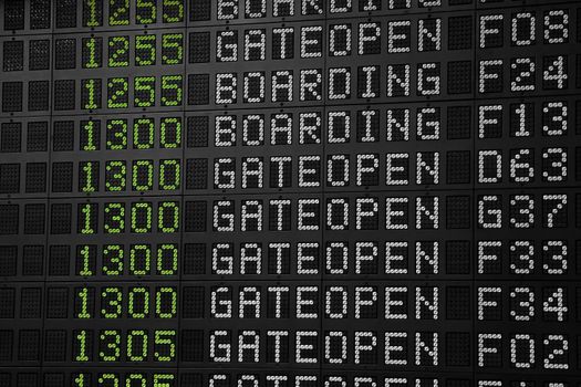 Flight information panel desk at airport, with time, flight number, boarding and gate open messages, close up, low angle view