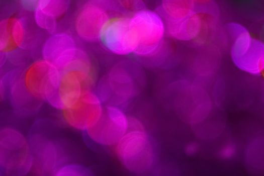 Colorful pink and purple bokeh defocused blurred lights and sparkles abstract background