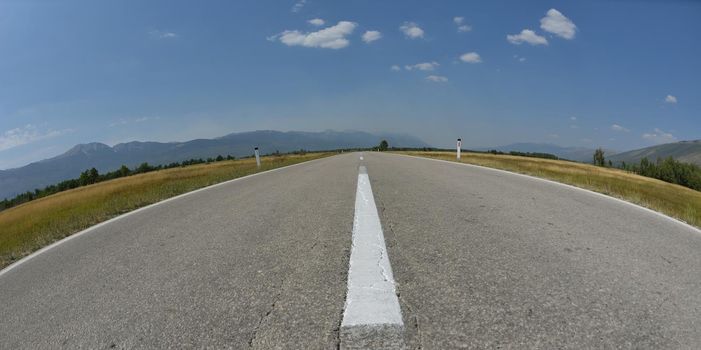 country road asphalt lines with beautiful nature and sunny summer day with blue sky