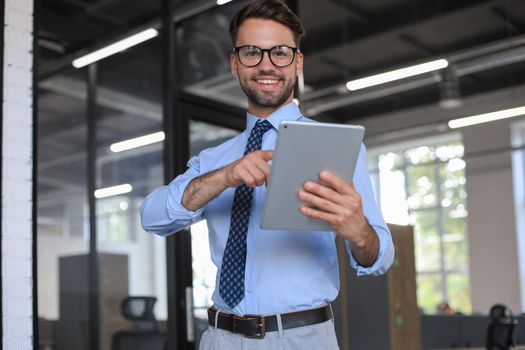 Young man using his tablet in the office.