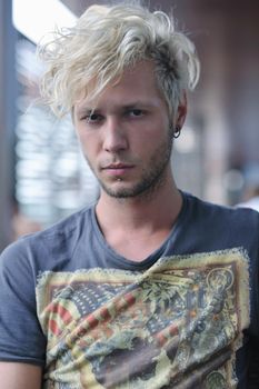 Portrait of an handsome young  man  with urban background and fashion clothes style