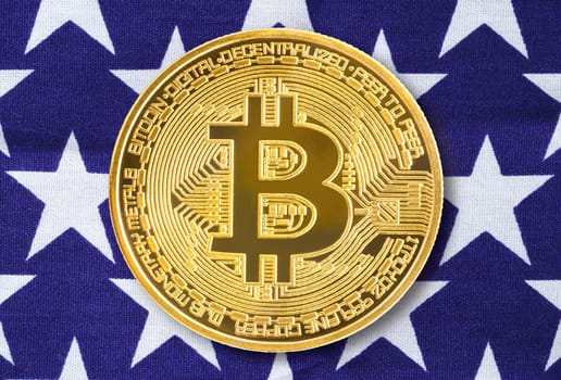 Crypto currency concept. Gold Bitcoin coin on flag of United States of America USA background