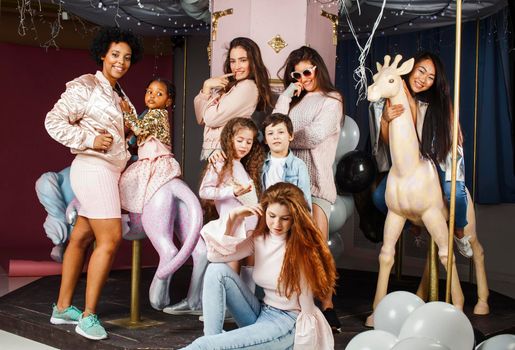 Lifestyle and people concept: young pretty diversity nations woman with different age children celebrating on birth day party together happy smiling, making selfie. African-american, asian and caucasian close up