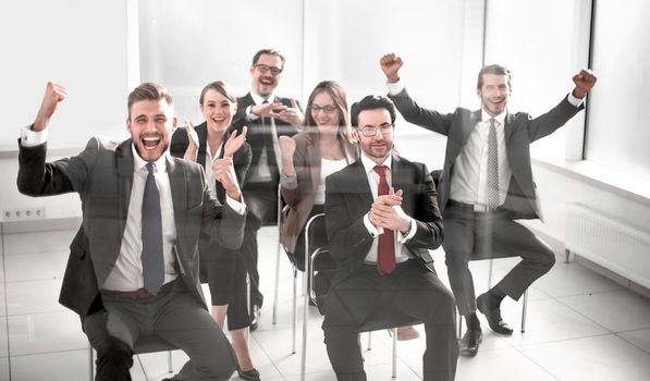 happy business team sitting in conference room. Business and entrepreneurship