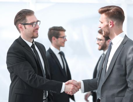 handshake of business partners on a light background .business concept