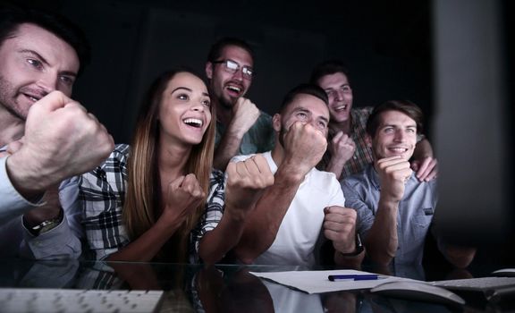 gambling business team looks at the computer monitor. success concept