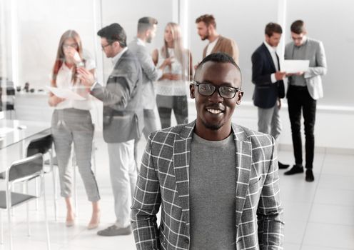 young businessman standing in the hall of the modern office .business concept