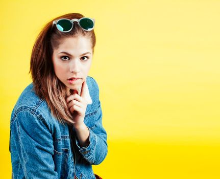 lifestyle people concept: pretty young school teenage girl having fun happy smiling on yellow background close up