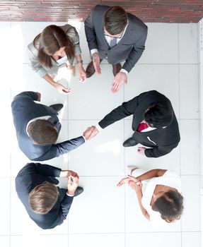 top view.business partners shaking hands.business concept