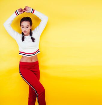 lifestyle people concept: pretty young school teenage girl having fun happy smiling on yellow background close up